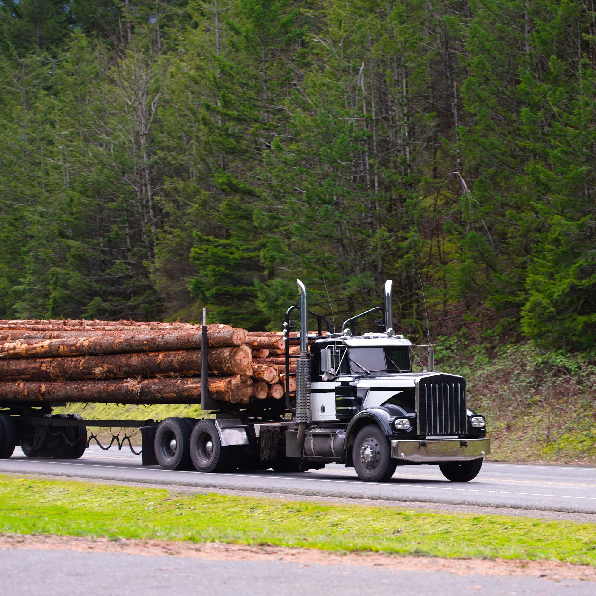 Image of a semi truck hauling wood and if it wrecks it will need a Truck Accident Lawyer Peoria IL
