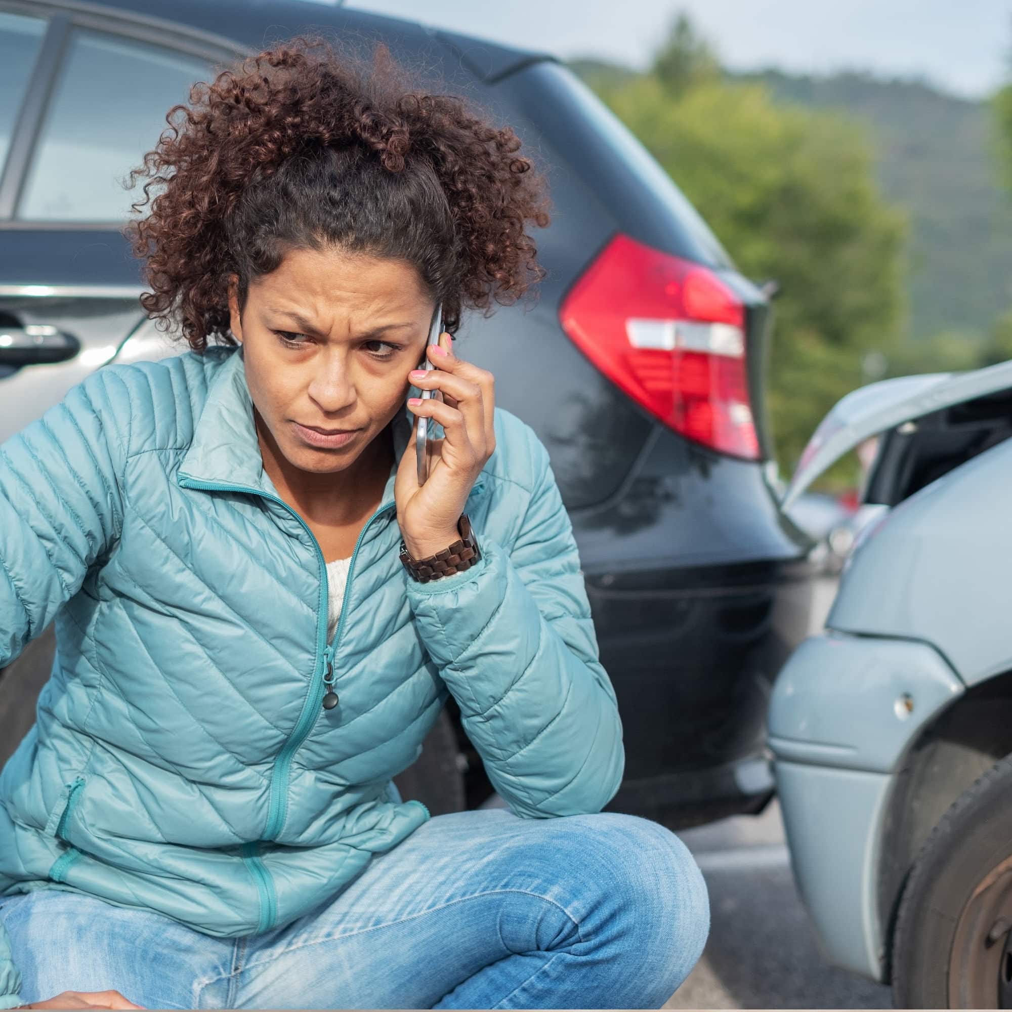 image of a women on the phone after a car accident asking What is the Average Settlement for a Car Accident in Illinois?